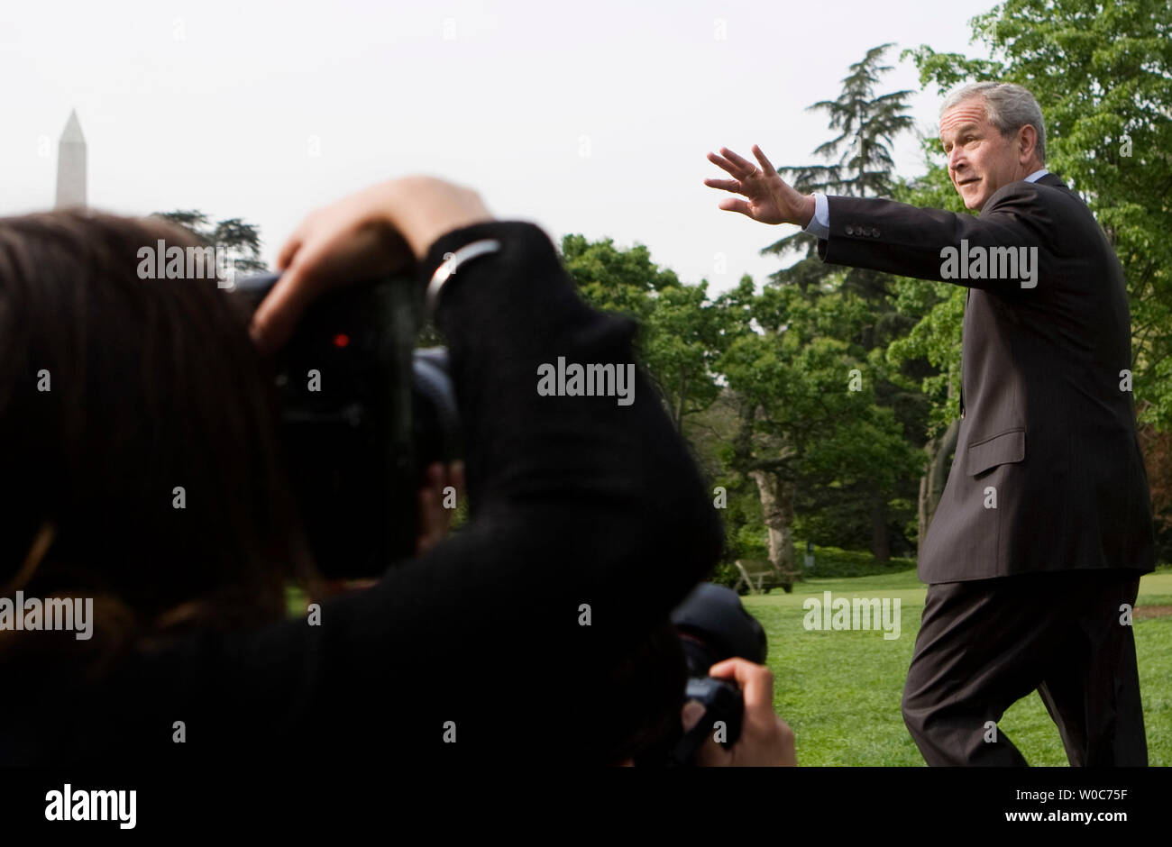 U.S. President George W. Bush waves to members of the media after making a statement on the economic stimulus rebate checks before departing the White House in Washington on April 25, 2008. (UPI Photo/Patrick D. McDermott) Stock Photo
