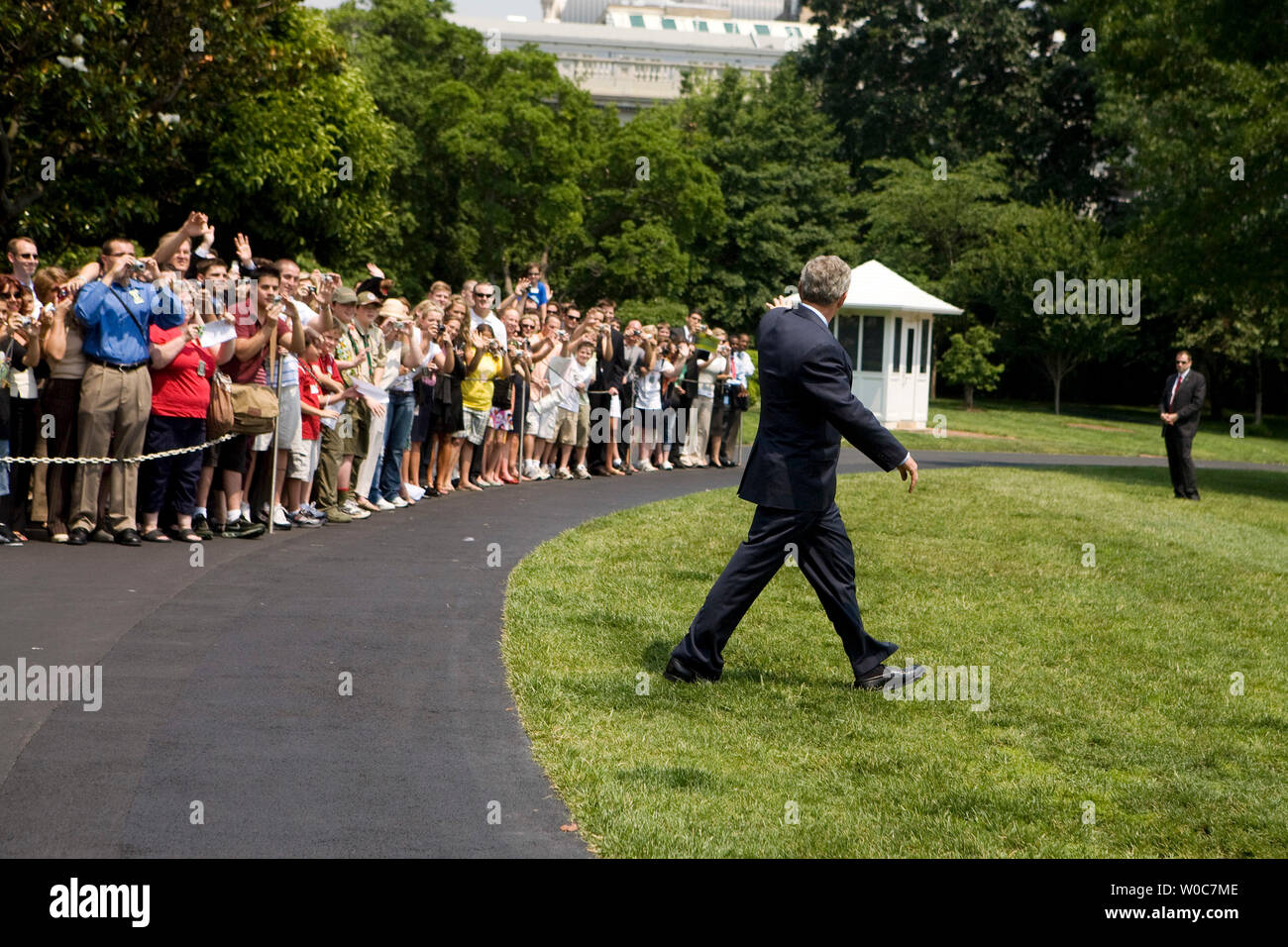 U.S. President George W. Bush waves to members of the public as he walks on the South Lawn of the White House toward Marine One in Washington on June 6, 2008. President Bush is going to Camp David for the weekend. (UPI Photo/Patrick D. McDermott) Stock Photo