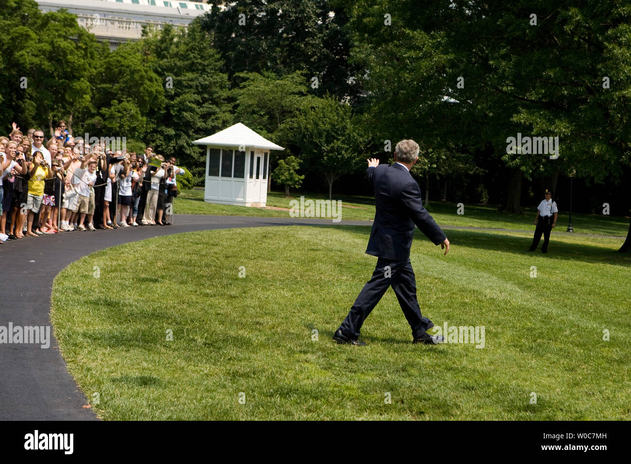 U.S. President George W. Bush waves to members of the public as he walks on the South Lawn of the White House toward Marine One in Washington on June 6, 2008. President Bush is going to Camp David for the weekend. (UPI Photo/Patrick D. McDermott)  (UPI Photo/Patrick D. McDermott) Stock Photo