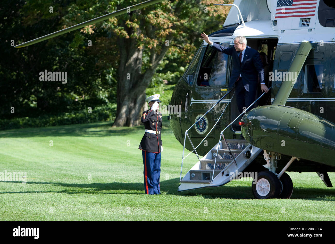 President George W. Bush waves as he steps off Marine One on the South Lawn at the White House in Washington on August 11, 2008. Bush has returned from attending some of the 2008 Olympics Games in Beijing. (UPI Photo/Patrick D. McDermott) Stock Photo
