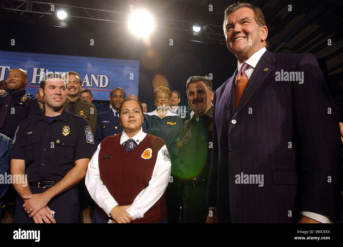 Tom Ridge, secretary of the Department of Homeland Security, and members of his department watch President Bush shake hands with the crown after Bush signed the Homeland Security Appropriations Act into law at the department' headquarters in Washington on Oct. 1, 2003.    UPI PHOTO/ROGER L. WOLLENBERG Stock Photo