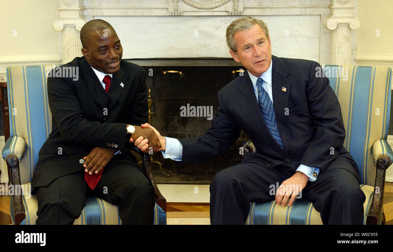 U.S. President George W. Bush shakes hands with President of the Democratic Republic of Congo Joseph Kabila in the Oval Office of the White House on Nov. 5, 2003. The two leaders discussed issues of common interest, including regional stability, HIV/AIDS and the global war on terrorism a White House official said.    (UPI/Roger L. Wollenberg) Stock Photo