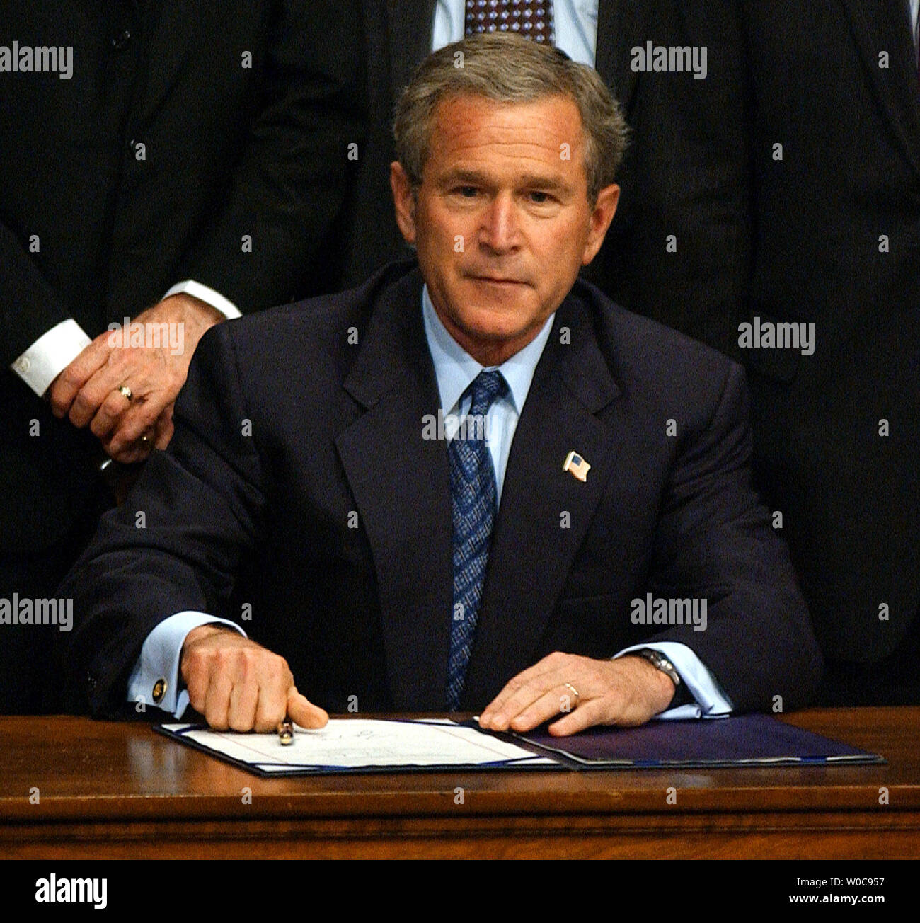 President George W. Bush sets  his pen down after signing a bill banning partial birth abortions on November 5, 2003, in Washington. In remarks the President said his administration would vigorously defend the legality of the bill.    (UPI/Roger L. Wollenberg) Stock Photo