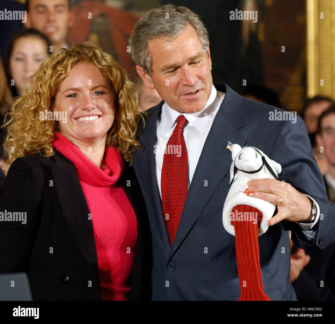 President George W. Bush checks out a golf wood cover given to him by Mikaela Parmlid, University of Southern California Women's Golf, during a ceremony honoring NCAA champion teams in the East Room of the White House on November 17, 2003. Present were University of Illinois-Champaign Men's Tennis, University of Florida Women's Tennis, University of Virginia Men's Lacrosse, Princeton's Women's Lacrosse, Rice University Men's Baseball, UCLA Women's Softball, Clemson University Men's Golf, and University of Southern California Women's Golf.   (UPI Photo/Roger L. Wollenberg) Stock Photo