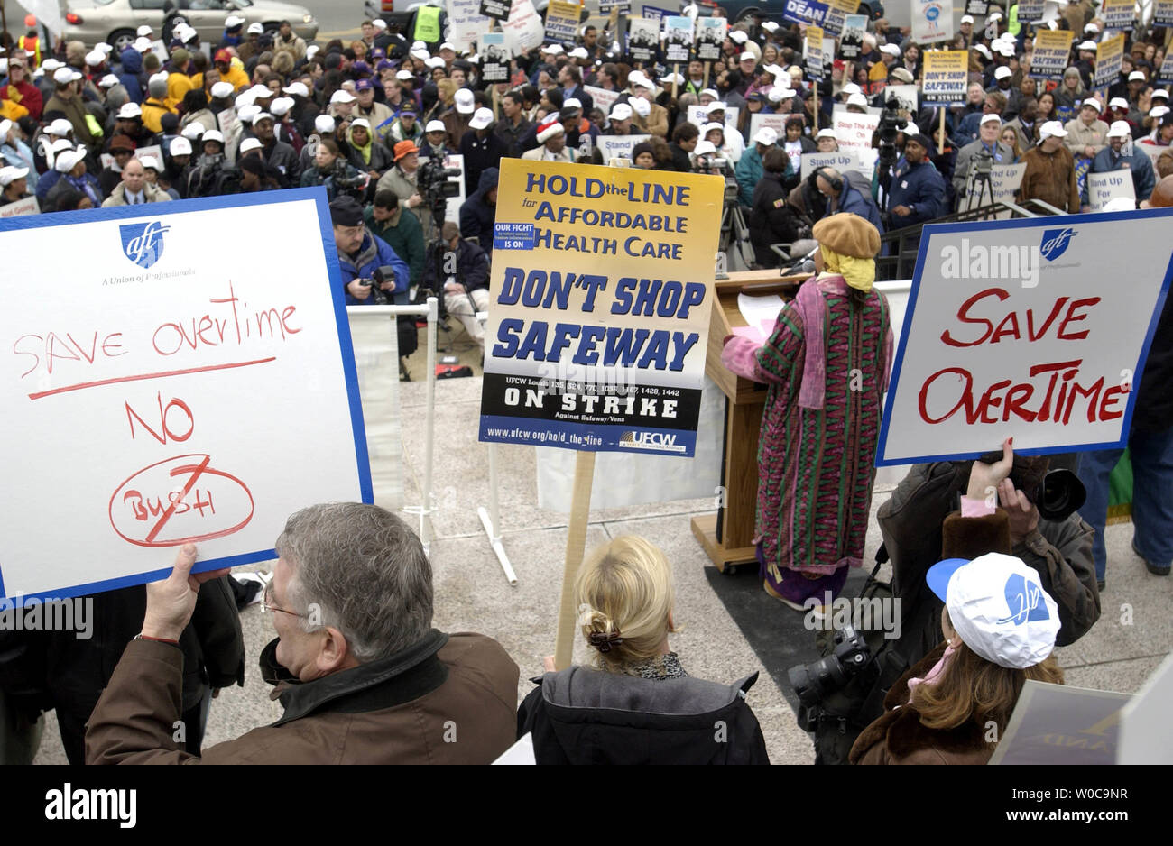Union members are led in song at the start of a protest rally in front of the Department of Labor on December 10, 2003 in Washington.  The unions were there for workers rights, increases in over time pay and to speak out against President George W. Bush's labor policies in general.    (UPI Photo/Michael Kleinfeld) Stock Photo