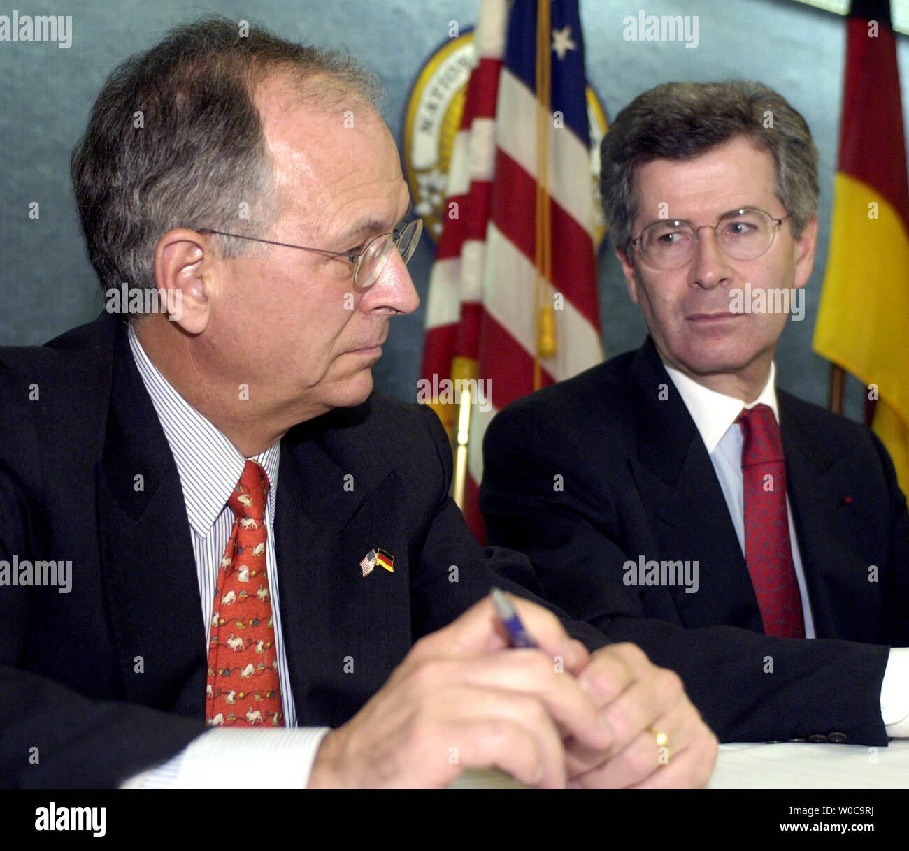 French Ambassador to the United States Jean David Levitte left, and German Ambassador to the United States Wolfgang Ischinger decide who will anwser the next question during an anouncement of a new program between the United States, France and Germany at the National Press Club on December 12, 2003 in Washington.  Both gentlemen tried to avoid questions regarding the decision by the United States to keep companies from their countries from gaining  contracts in Iraq. (UPI Photo/Michael Kleinfeld) Stock Photo
