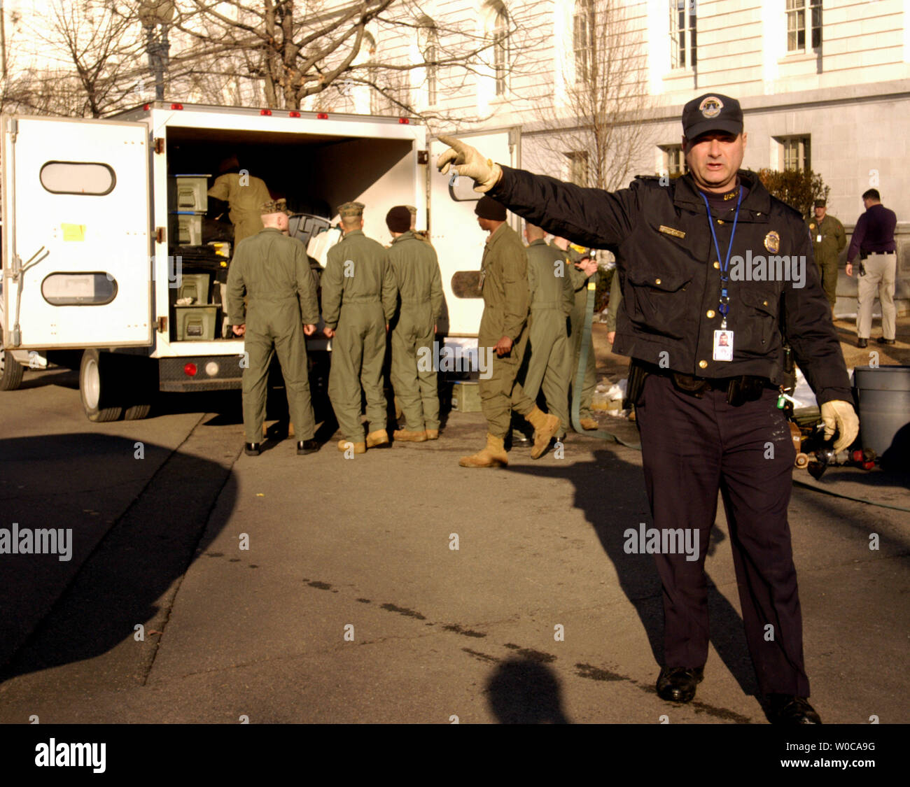 A Capitol Hill police officer tells people to clear the area as marines from the 4th MEB (AT) set up a cleaning station for biohazards materials outside the Russell Senate office building, on February 4, 2004 in Washington.  Three senate office buildings are being sanitized after ricin was discovered two days earlier in the mail room of Sen. Bill Frist, R-Tenn. (UPI Photo/Michael Kleinfeld) Stock Photo