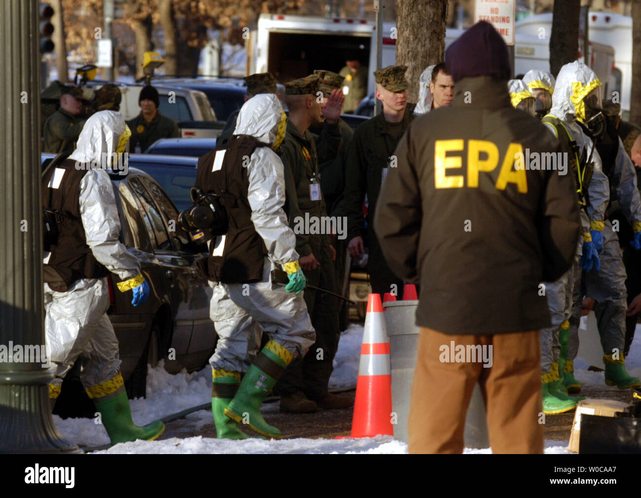 Marines from the 4th MEB (AT) march into the Russell office building as EPA officials look on, on February 4, 2004 in Washington.  Three senate office buildings are being sanitized after ricin was discovered two days earlier in the mail room of Sen. Bill Frist, R-Tenn. (UPI Photo/Michael Kleinfeld) Stock Photo