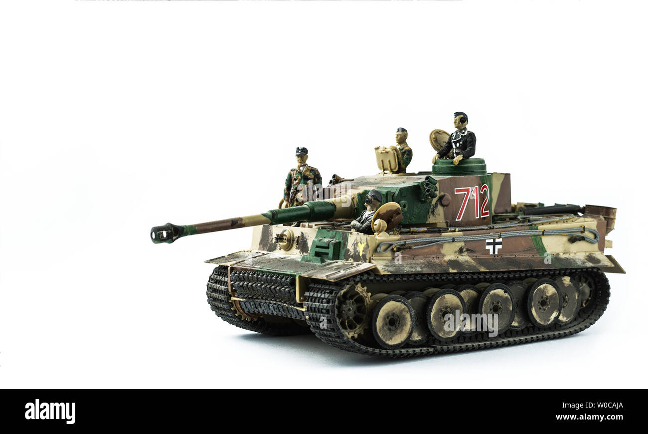 Old toy. Military tank with soldiers. Isolated on a white background. Stock Photo