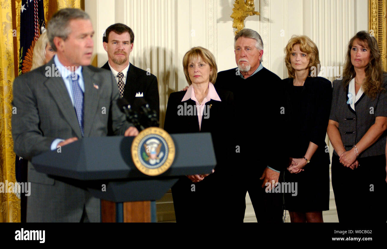 President George W. Bush speaks before signing the Unborn Victims of Violence Act of 2004 during a ceremony in the East Room of the White House on April 1, 2004. Behind Bush are family members of victims, from left to right, and victim's relatives Carol Lyons, Sharon Rocha, Buford Lyons, Tracy Marciniak-Seavers, Stephanie Alberts, Ron Grantski, and Cynthia Warner.    (UPI Photo/Rick Steele) Stock Photo