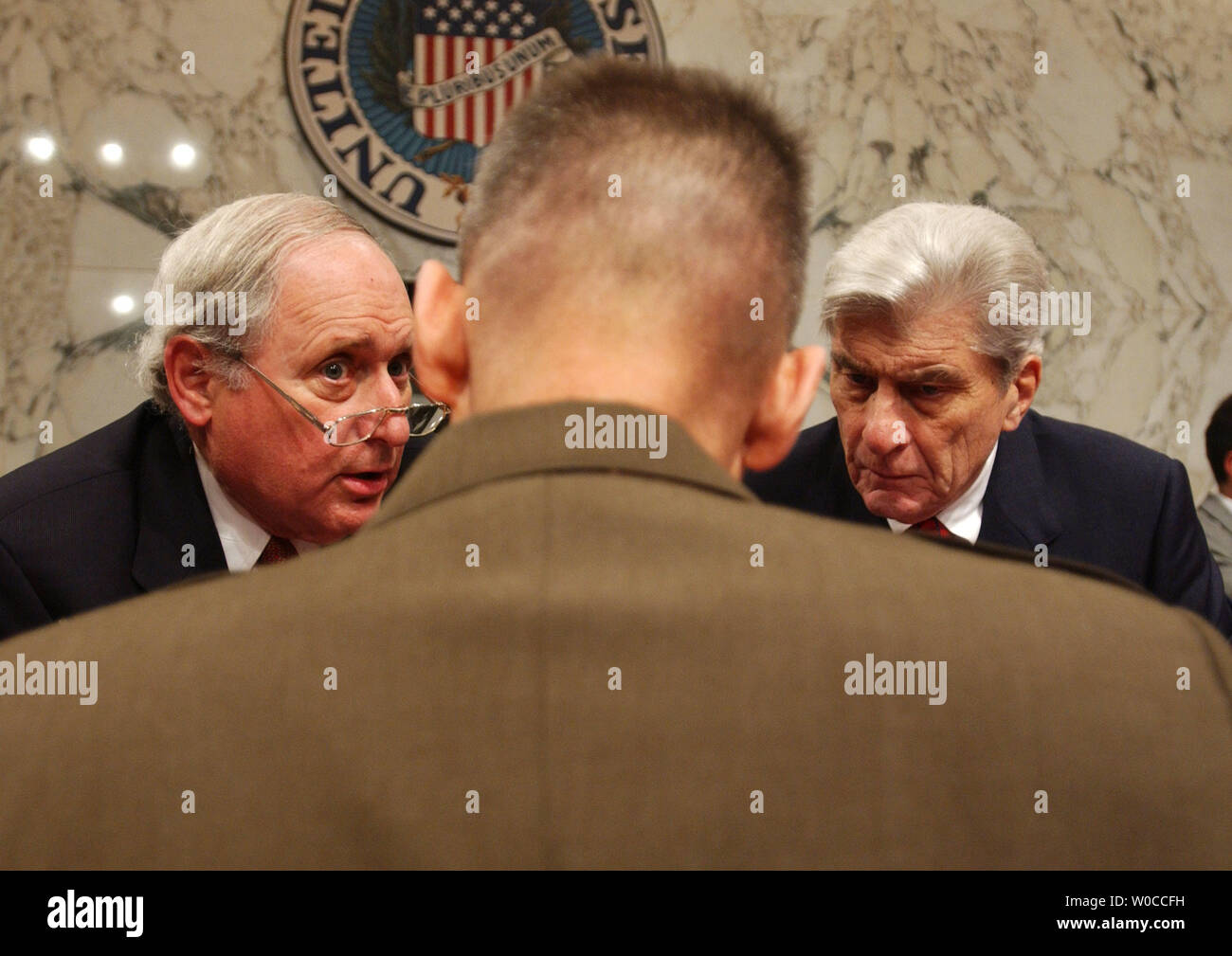 Sen. Carl Levin, D-MI, left, and Sen. John Warner, R-VA, right, speak with General Peter Pace before a hearing of the Senate Armed Service Committee on May 13, 2004 in Washington.  Pace and Deputy Secretary Wolfowitz are asking Congress for an additional $25 billion for the war in Iraq and Afghanistan. (UPI Photo/Michael Kleinfeld) Stock Photo