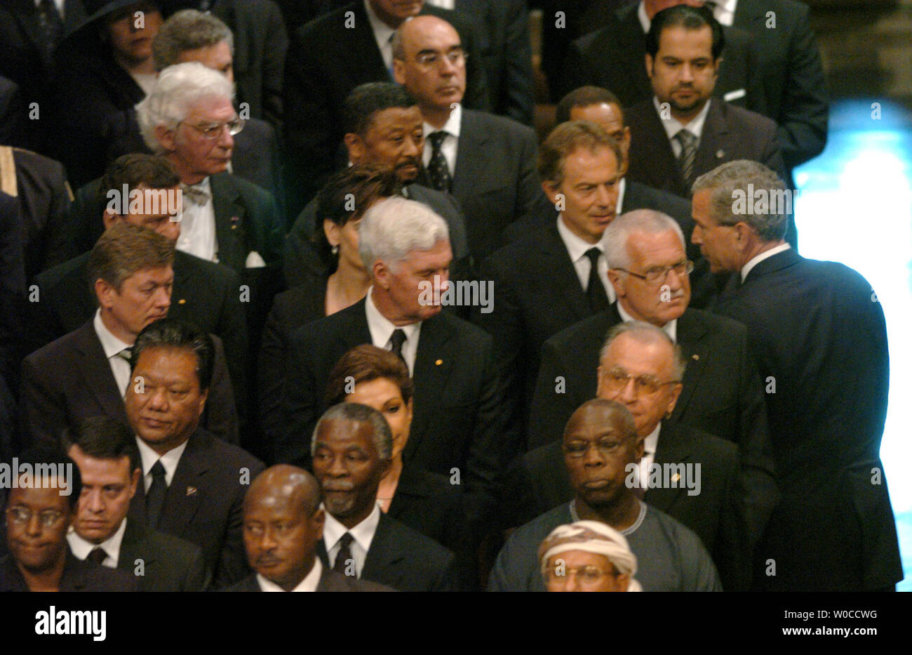 President George W. Bush stops to say hello British Prime Minister Tony Blair and other foreign leaders and their spouses after a State Funeral for former President Ronald Reagan at the National Cathedral in Washington June 11, 2004.  Leaders of the world paid tribute to the 40th president of the United States.  (UPI Photo/Pat Benic) Stock Photo