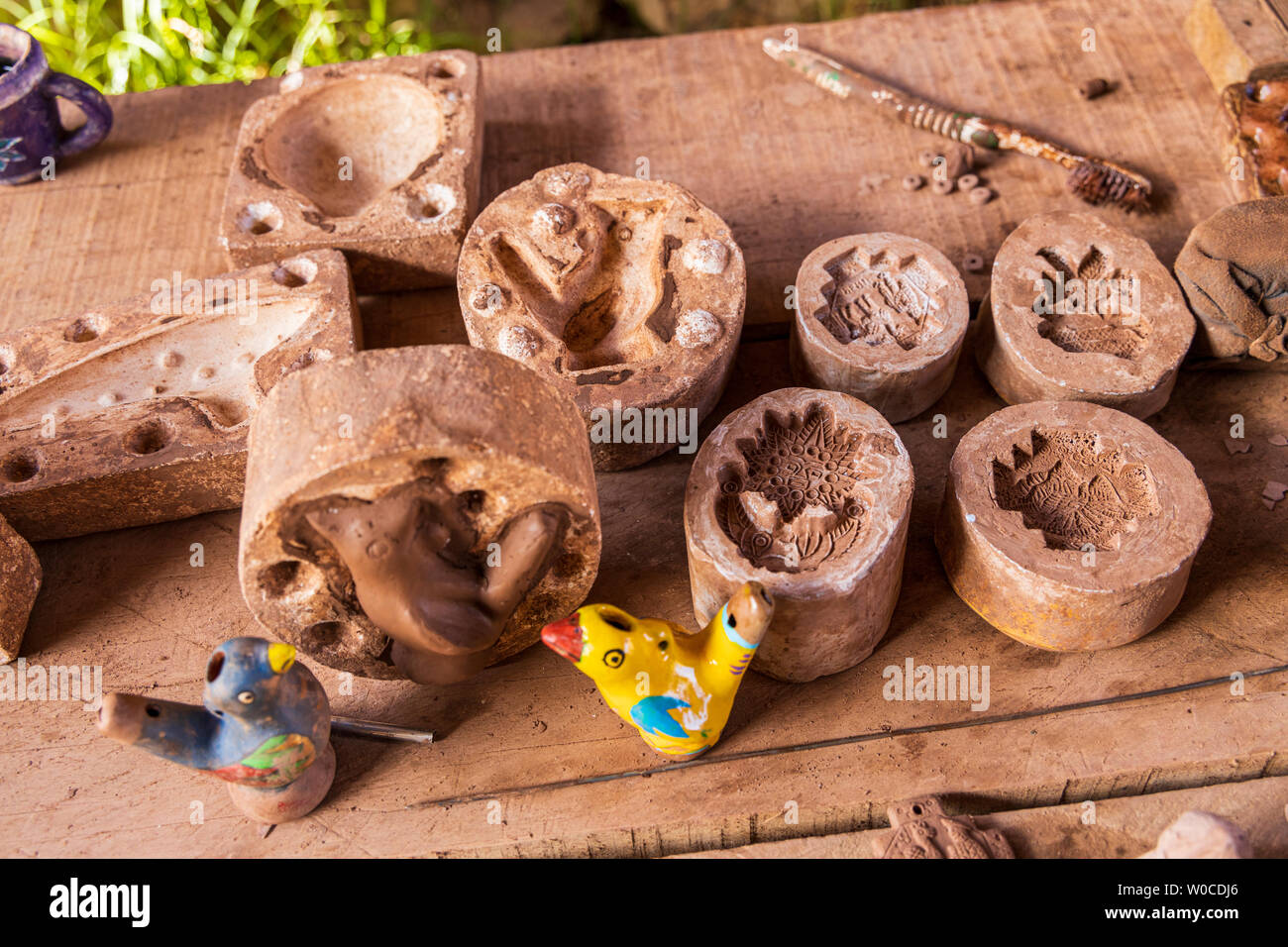 Pottery making clay models and hand painting them to sell as souvenirs, Pisac, Sacred Valley, Peru, South America, Stock Photo