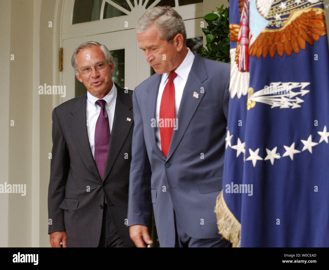 President George W. Bush enters the Rose Garden to announce to members of the press that he is nominating Rep. Porter Goss, left, R-FL, as the new head of the CIA, on August 10, 2004 in Washington. Goss is a former member of the CIA and sits on the House of Representatives Intelligence Committee. (UPI Photo/Michael Kleinfeld) Stock Photo