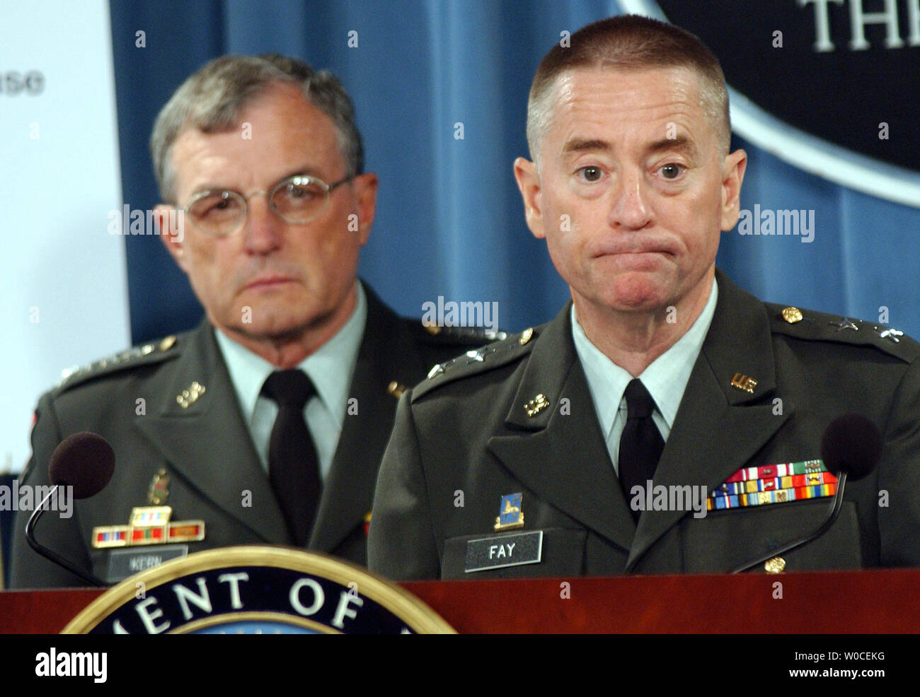 Gen. Paul Kern, left, and Maj. Gen. George Fay answer questions from reporters about abuse at the Abu Ghraib prison in Iraq during a news conference at the Pentagon on Aug. 25, 2004, in Arlington, Va. The Defense Department investigation found that less than 50 individuals were to blame for the abuses, but that officers above them in the chain of command made errors that led to the conditions that resulted in the abuses.  (UPI Photo/Roger L. Wollenberg) Stock Photo