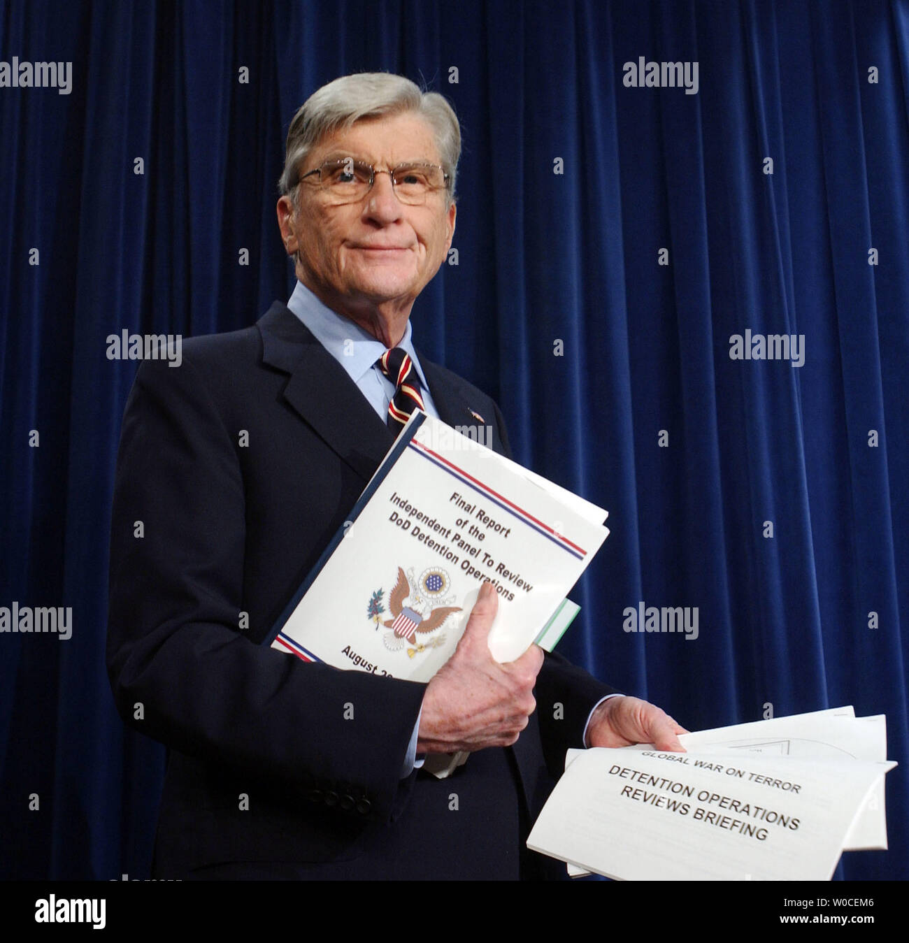 Sen. John Warner, R-VA, holds up a copy of the report on Dept. of Defense abuses in Iraq prior to a news conference on August 25, 2004 in Washington. Warner called the news conference to discuss the prisoner abuse at Abu Ghraib Prison and the Jones-Fay Report. (UPI Photo/Michael Kleinfeld) Stock Photo