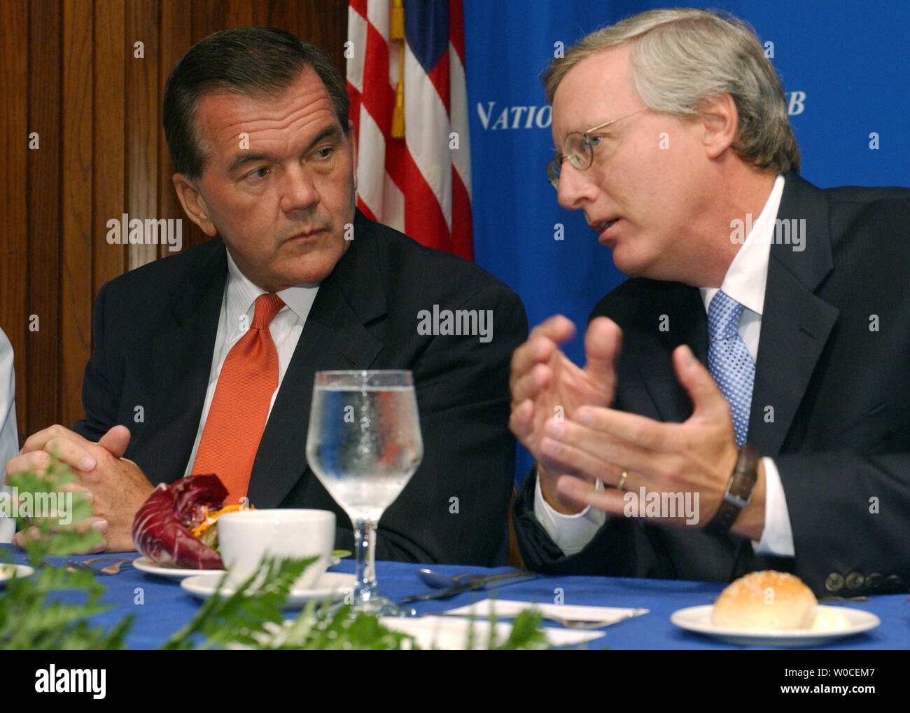 Secretary of Homeland Security Tom Ridge, left, speaks with U.S. Newswire's Bill McCarren during a luncheon at the National Press Club in Washington where Ridge spoke on Sept. 7, 2004. Ridge admitted there is still more work to be done, but insisted the U.S. was making progress in making the country safer, more secure, and more capable of responding to a terrorist attack or natural disaster.   (UPI Photo/Roger L. Wollenberg) Stock Photo