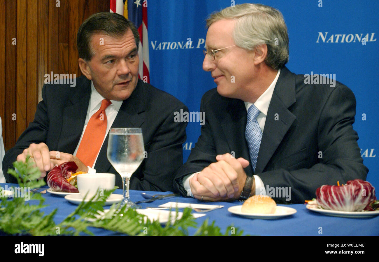 Secretary of Homeland Security Tom Ridge, left, speaks with U.S. Newswire's Bill McCarren during a luncheon at the National Press Club in Washington where Ridge spoke on Sept. 7, 2004. Ridge admitted there is still more work to be done, but insisted the U.S. was making progress in making the country safer, more secure, and more capable of responding to a terrorist attack or natural disaster.   (UPI Photo/Roger L. Wollenberg) Stock Photo