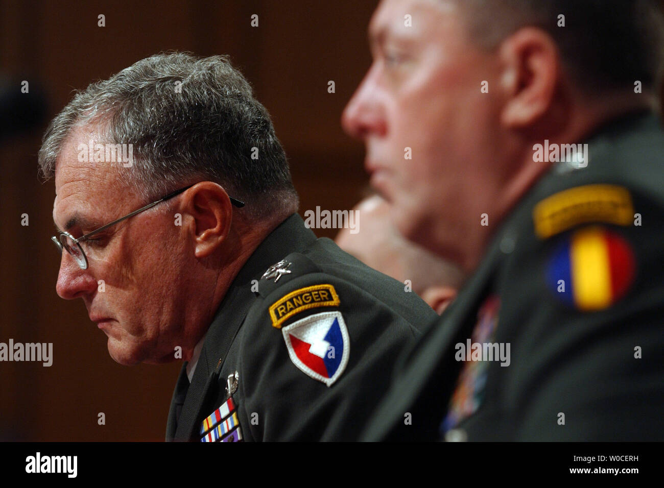 Gen. Paul Kern,  looks down while testifing before the Senate Armed Service Committee regarding the abuses of the 205th Military Intelligence Brigade at Abu Ghraib Prison, Iraq.  He said that mistakes were made because of a shortage of soldiers and general chaos.   Lt. Gen. Anthony Jones looks on. (UPI Photo/Michael Kleinfeld) Stock Photo