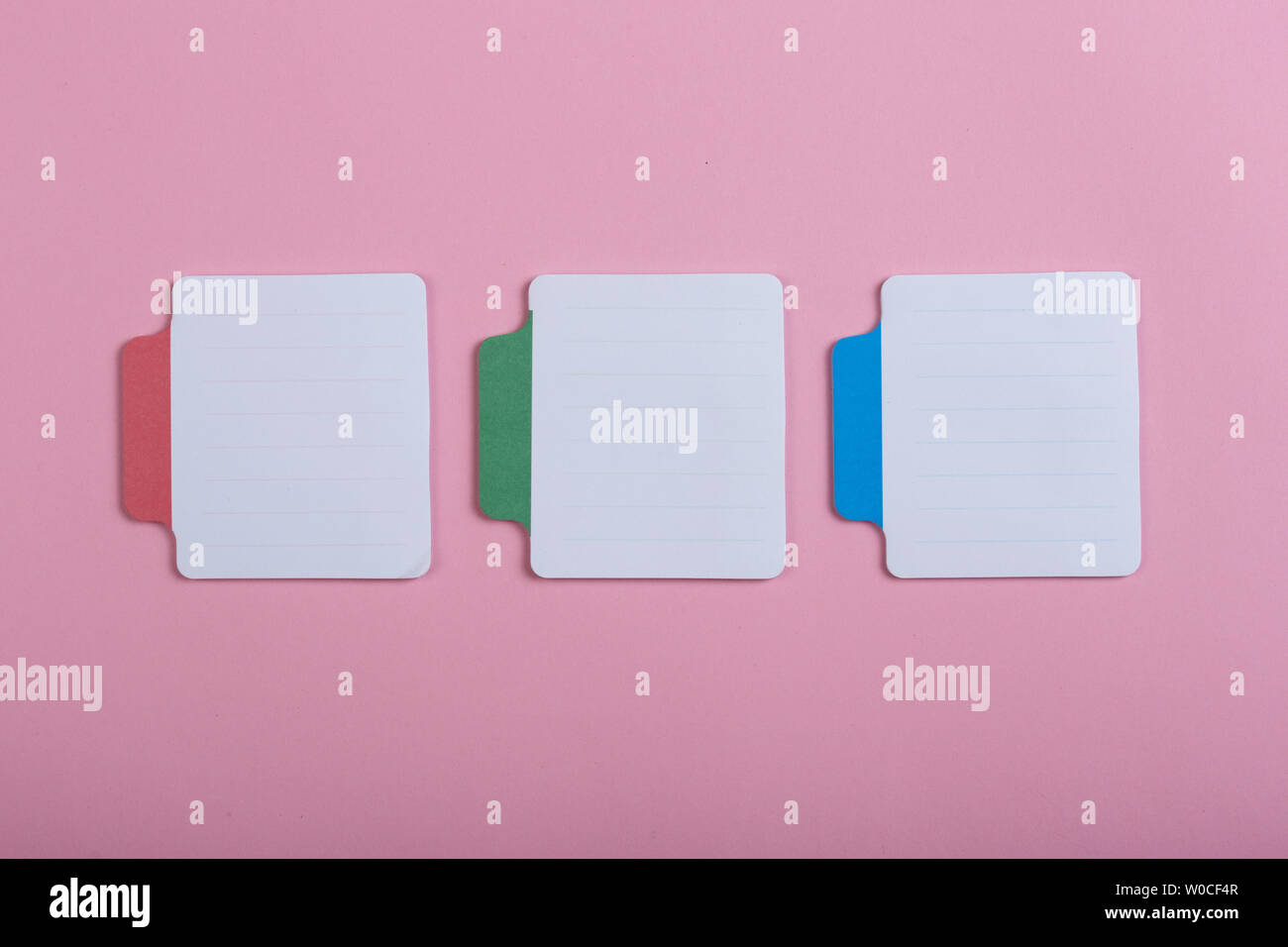 Many colorful sticky note on pink background. Copy space Stock Photo