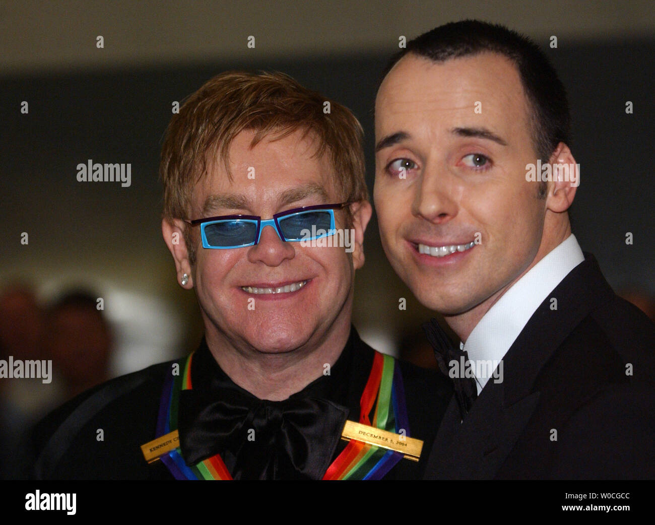 One of the 2004 Honorees, Elton John arrives at the Kennedy Center in Washington on December 5, 2004.  He is accompanied by David Furnish.  The Kennedy Center Honors celebrates men and women who have contributed to society in their selected field of the arts. (UPI Photo/Michael Kleinfeld) Stock Photo