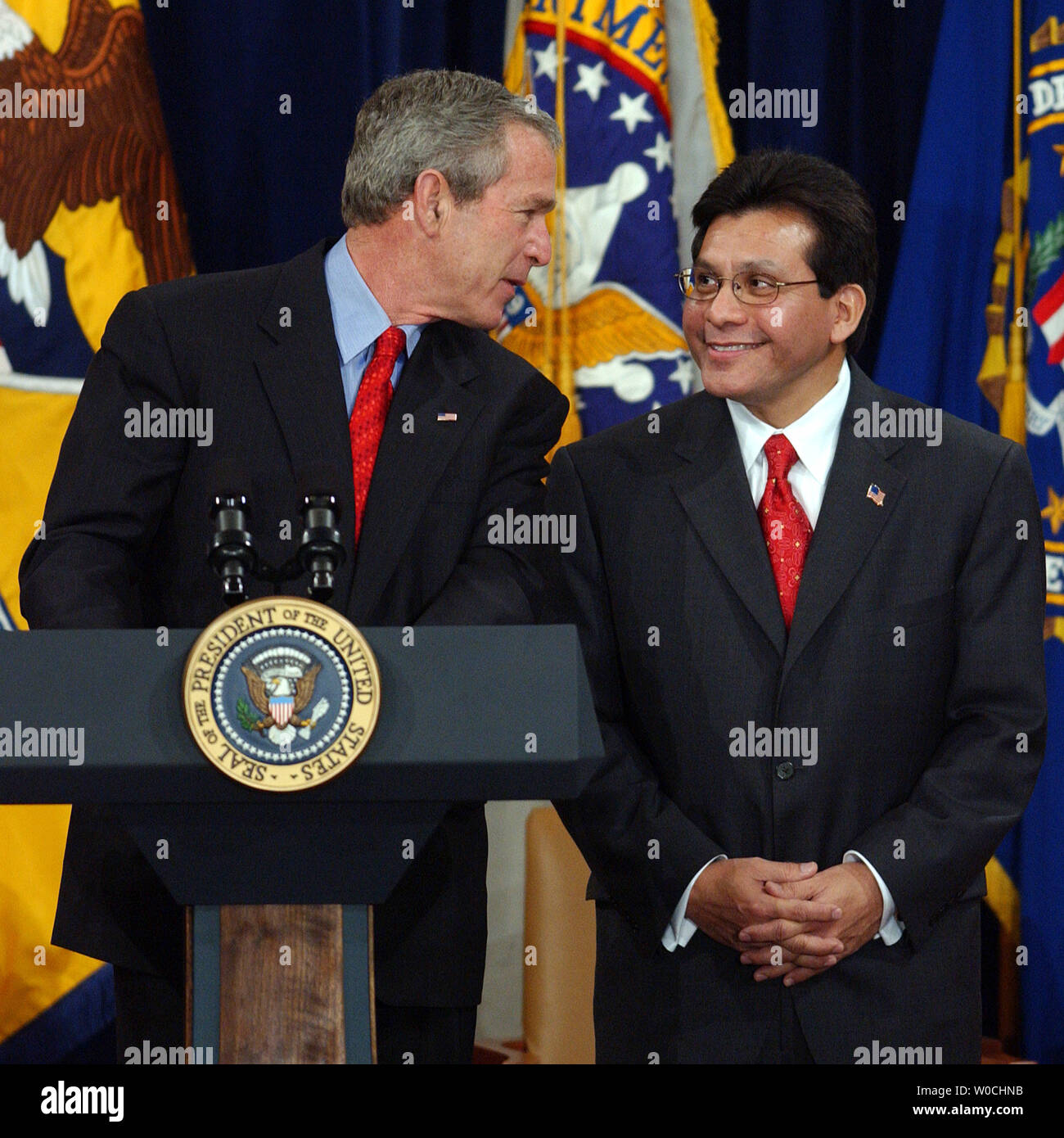 Attorney General Alberto Gonzales speaks with U.S. President George W. Bush after the Attorney General's swearing-in ceremony at the Justice Department in Washington on Feb. 14, 2005.   (UPI Photo/ROGER L. WOLLENBERG) Stock Photo