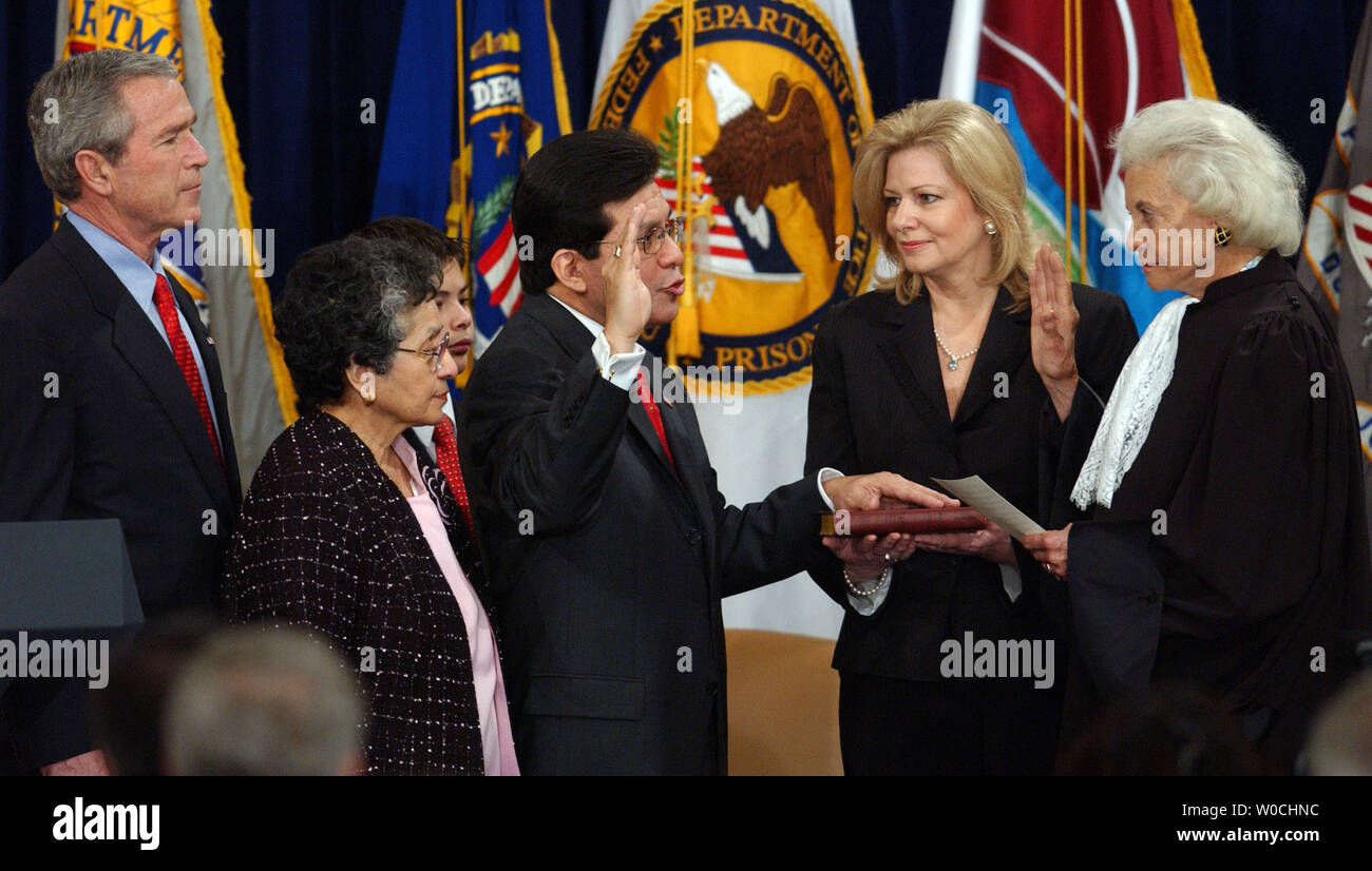 Attorney General Alberto Gonzales is sworn in by Supreme Court Justice Sandra Day O'Connor, at the Justice Department in Washington on Feb. 14, 2005. U.S. President George W. Bush and Gonzales' mother Maria look on as his wife Rebecca holds the bible.  (UPI Photo/ROGER L. WOLLENBERG) Stock Photo