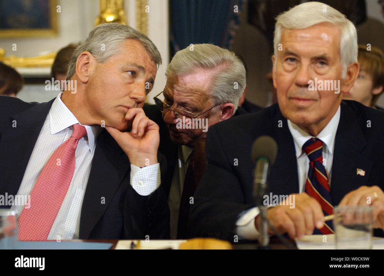 Sen. Chuck Hagel, R-Neb., left, speaks with an aid as Sen. Richard Lugar, R-IN, chairs the Senate Foreign Relations Committee meeting which was held to vote on John Bolton to be U.S. Ambassador to the United Nations on Capitol Hill in Washington on April 19, 2005. The committee chose to delay the vote after Sens. Chuck Hagel, R-Neb. and George Voinovich, R-Ohio, expressed concern allegations against him.   (UPI Photo/Roger L. Wollenberg) Stock Photo