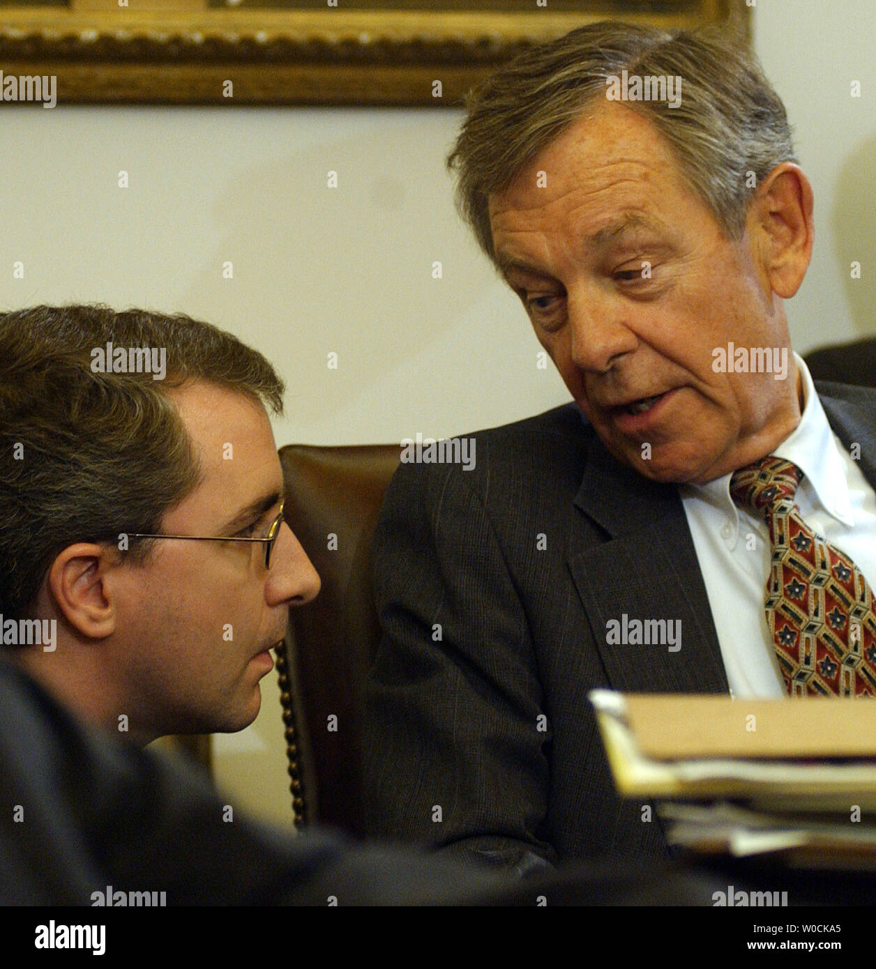 Sen. George Voinovich, R-Ohio, speaks to an aid during the Senate Foreign Relations Committee meeting which was held to vote on John Bolton to be U.S. Ambassador to the United Nations on Capitol Hill in Washington on April 19, 2005. The committee chose to delay the vote after Sens. Chuck Hagel, R-Neb. and George Voinovich, R-Ohio, expressed concern allegations against him.   (UPI Photo/Roger L. Wollenberg) Stock Photo