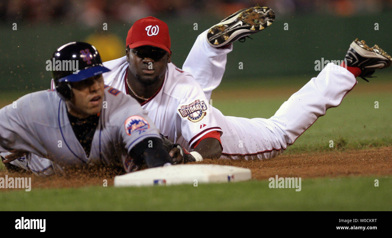 Washington Nationals second basemen Cristian Guzman makes a diving tag out on New York Met's center fielder Carlos Beltran during the second inning at RFK Stadium in Washington, DC on May 1, 2005. (UPI Photo/Kevin Dietsch) Stock Photo