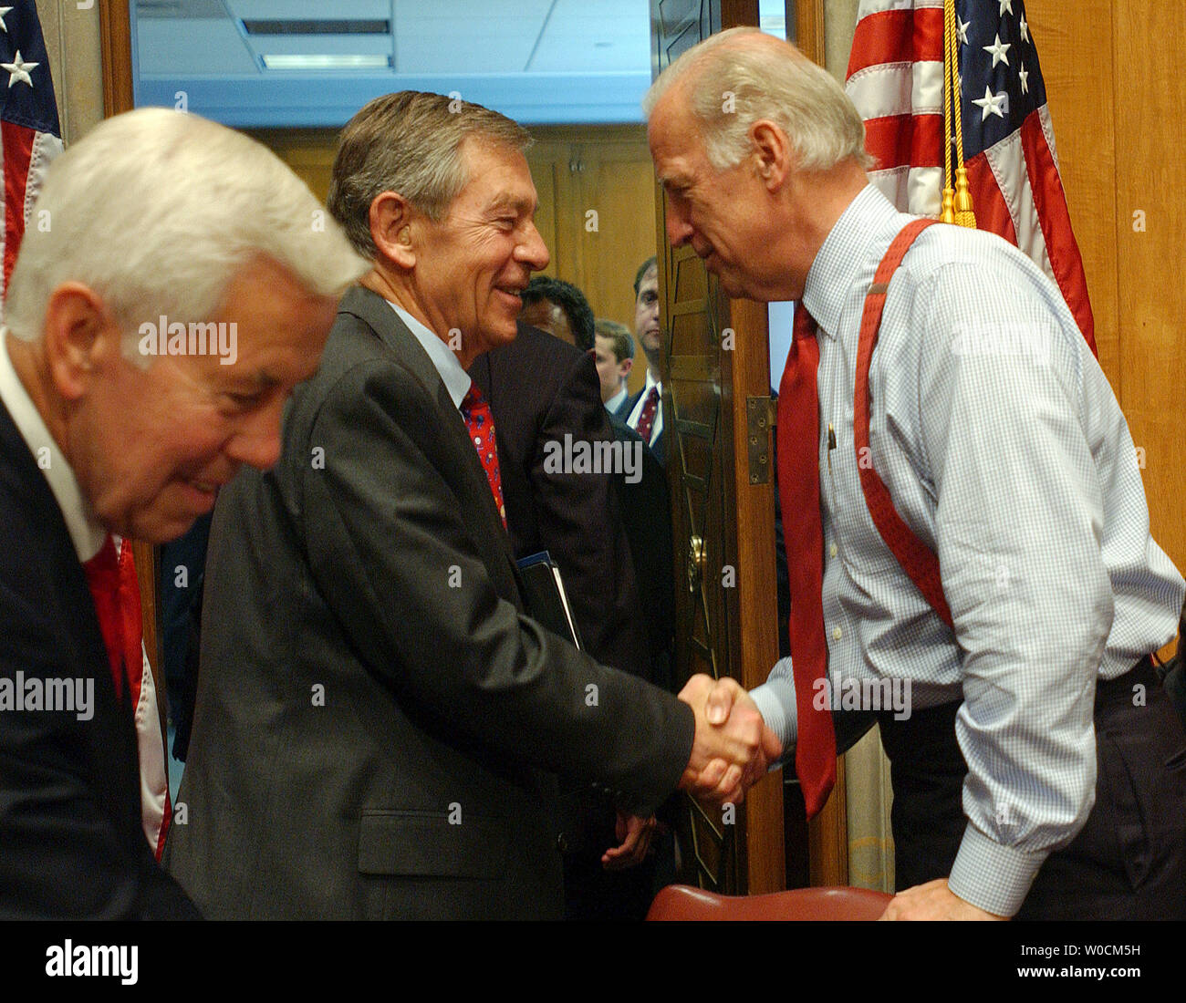 Sen. George Voinovich, R-OH, shakes hands with Sen. Joe Biden, D-CT as Sen. Richard Lugar, R-IN) prepares to exit after a Senate Foreign Relations Committee meeting to vote on the nomination of John Bolton to be the U.S. ambassador to the U.N. on May 12, 2005, on Capitol Hill in Washington. Voinovich opposes Bolton, but voted to allow the full Senate to vote on the nomination.   (UPI Photo/Roger L. Wollenberg) Stock Photo