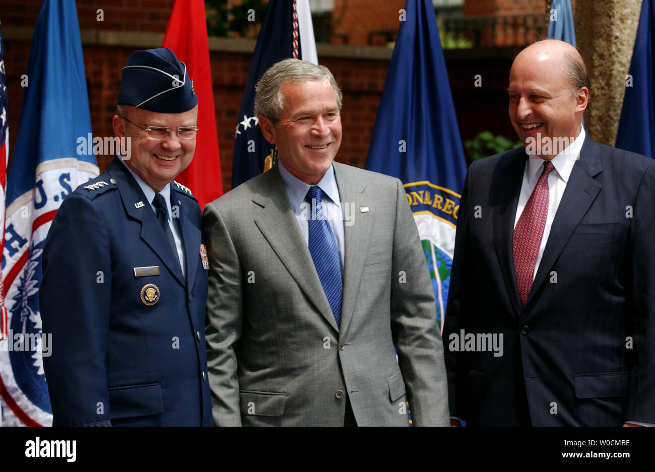 U.S. President George W. Bush jokes with U.S. Deputy Director of National Intelligence, U.S. Air Force Lt Gen. Michael Hayden, left, and the first Director of National Intelligence, John Negroponte, right, after a ceremony to swear both into their new jobs on May 18, 2005 in Washington.  The new positions will coordinate national and international intelligence in a way deemed necessary after the attacks on 9/11. (UPI Photo/Michael Kleinfeld) Stock Photo