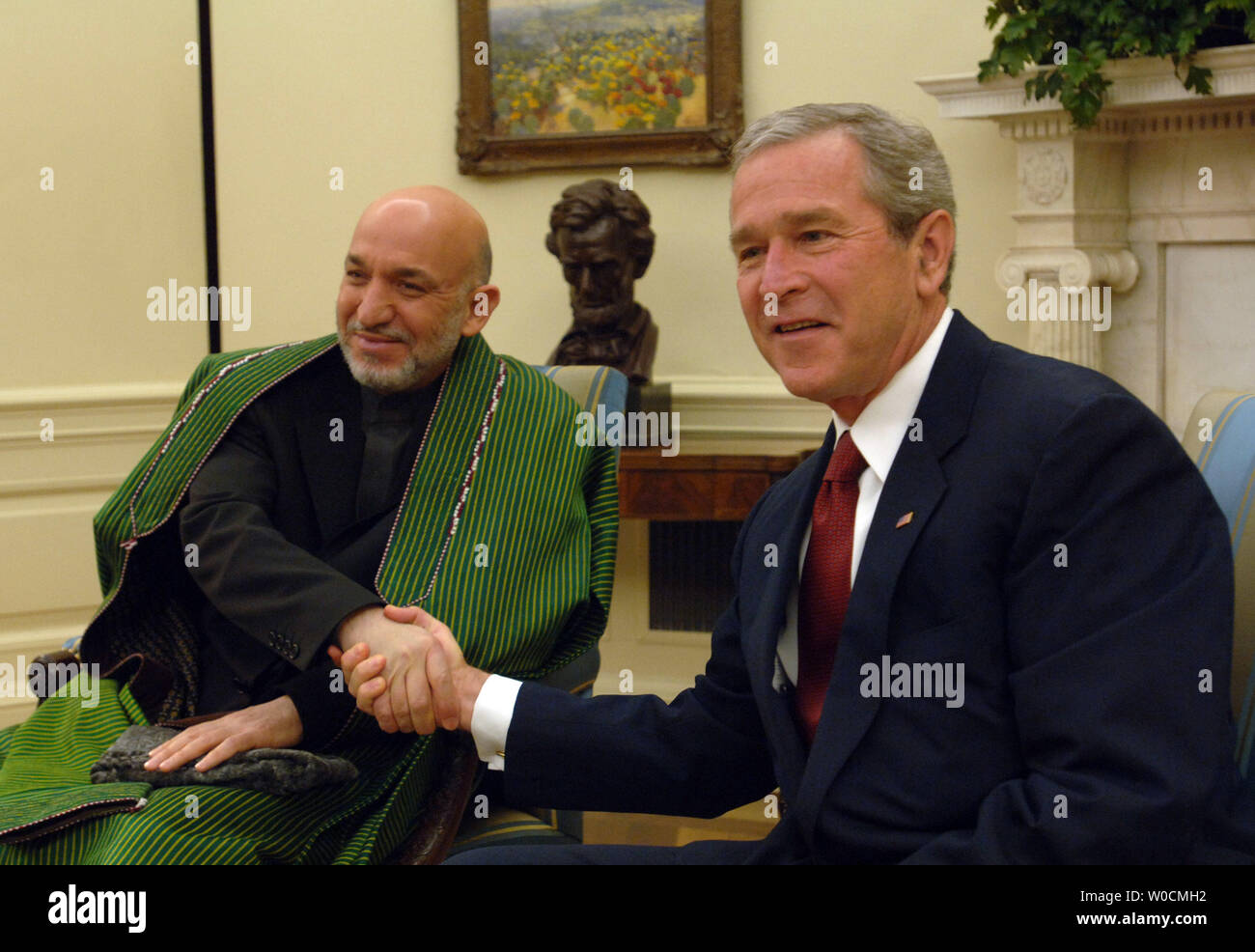 Afghan President Hamid Karzai, left, is welcomed to the oval office by President George W. Bush, on May 23, 2005 in Washington.  Bush and Karzai talked about prisoner abuse, drug production and the war in Iraq.  (UPI Photo/Michael Kleinfeld) Stock Photo