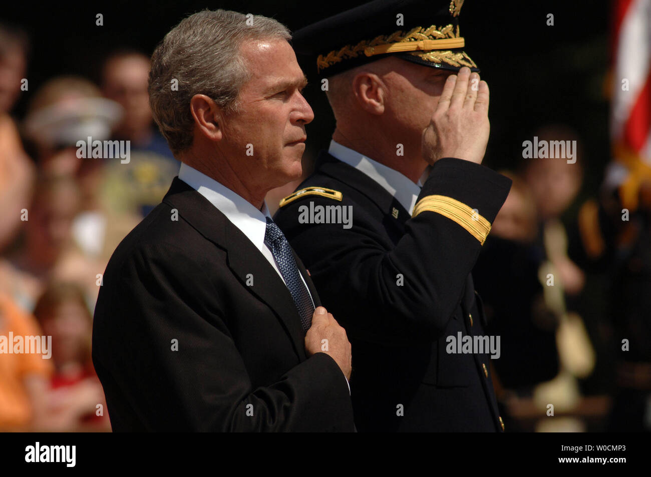 President George W. Bush covers his heart while participating in a Memorial Day ceremony at the Tomb of the Unknowns, on May 30, 2005 in Arlington National Cemetery. Maj. Gen. Galen B. Jackman stands on the President's right.  This year, members of the armed services paid special tribute to those who have died in Iraq and Afghanistan.  (UPI Photo/Michael Kleinfeld) Stock Photo