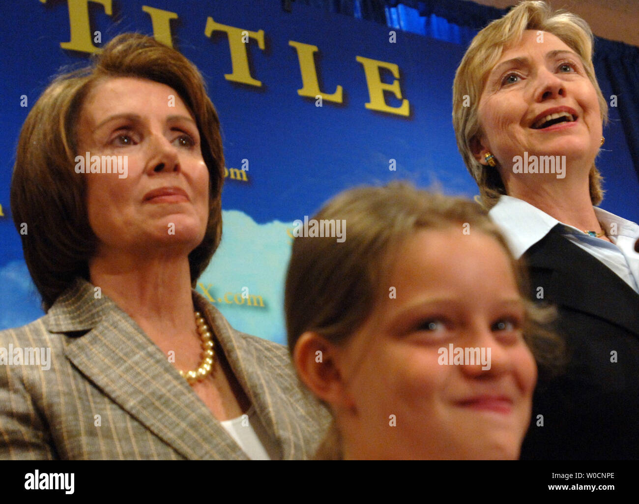 House Minority Leader Nancy Pelosi, D-CA, left, and Sen. Hilliary Clinton, D-NY, cheer on young soccer players at an event to high-light the positive effects of 'Title Nine', on June 22, 2005.  Title Nine has given young women access to money for scholarships in sports, and has contributed to elevating the status of women in sports.  The Bush administration is threatening to change to law; making is weaker and less effective according to critics. (UPI Photo/Michael Kleinfeld) Stock Photo