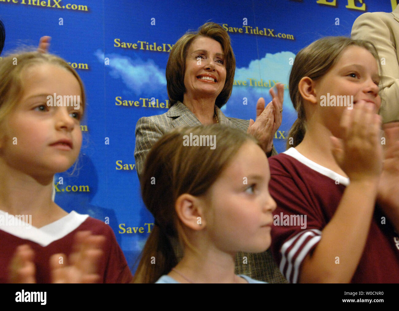 House Minority Leader Nancy Pelosi, D-CA, cheers on young soccer players at an event to high-light the positive effects of 'Title Nine', on June 22, 2005.  Title Nine has given young women access to money for scholarships in sports, and has contributed to elevating the status of women in sports.  The Bush administration is threatening to change to law; making is weaker and less effective according to critics. (UPI Photo/Michael Kleinfeld) Stock Photo