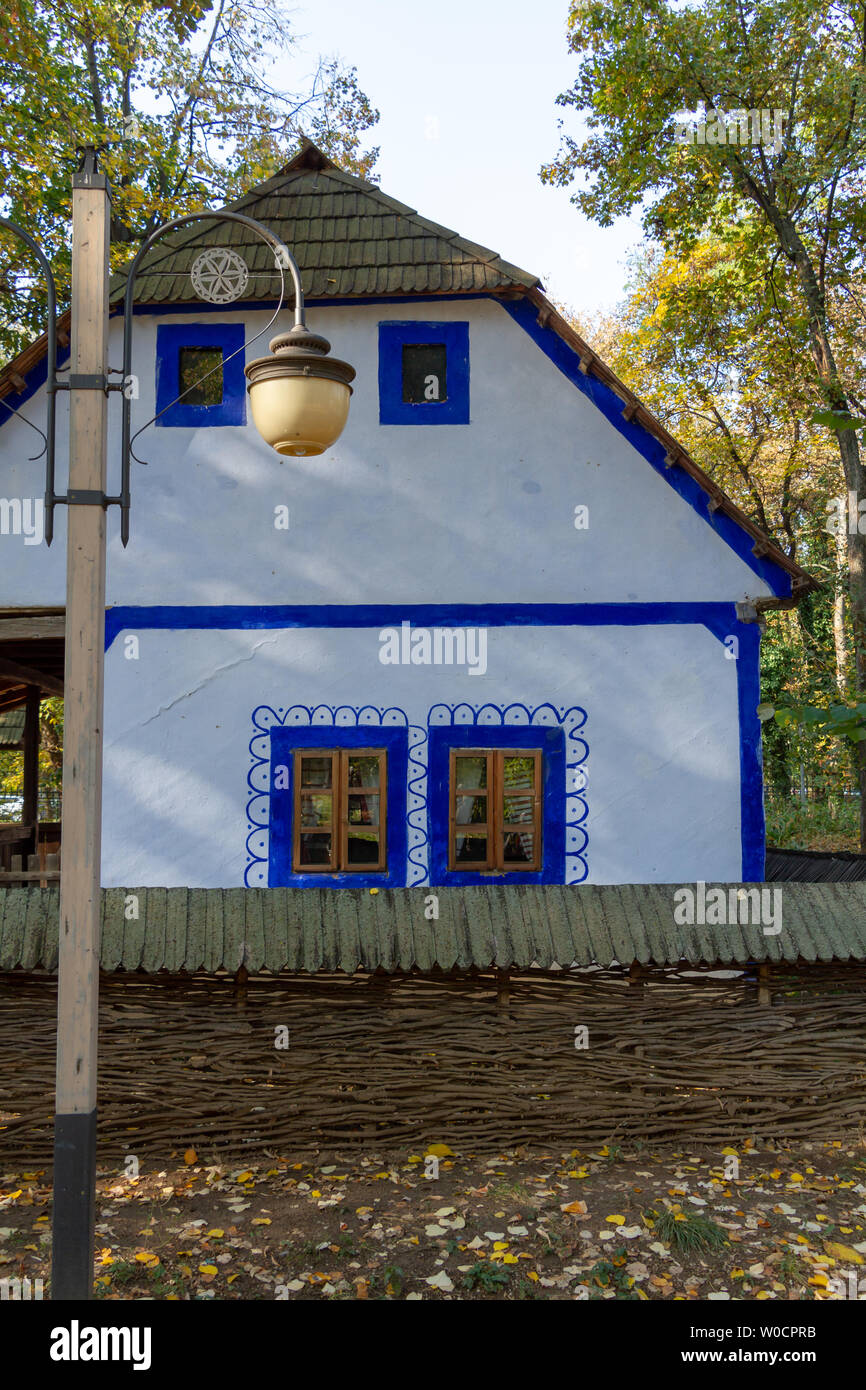 Blue windowed, whitewashed, traditional house - Village Museum of Bucharest Stock Photo
