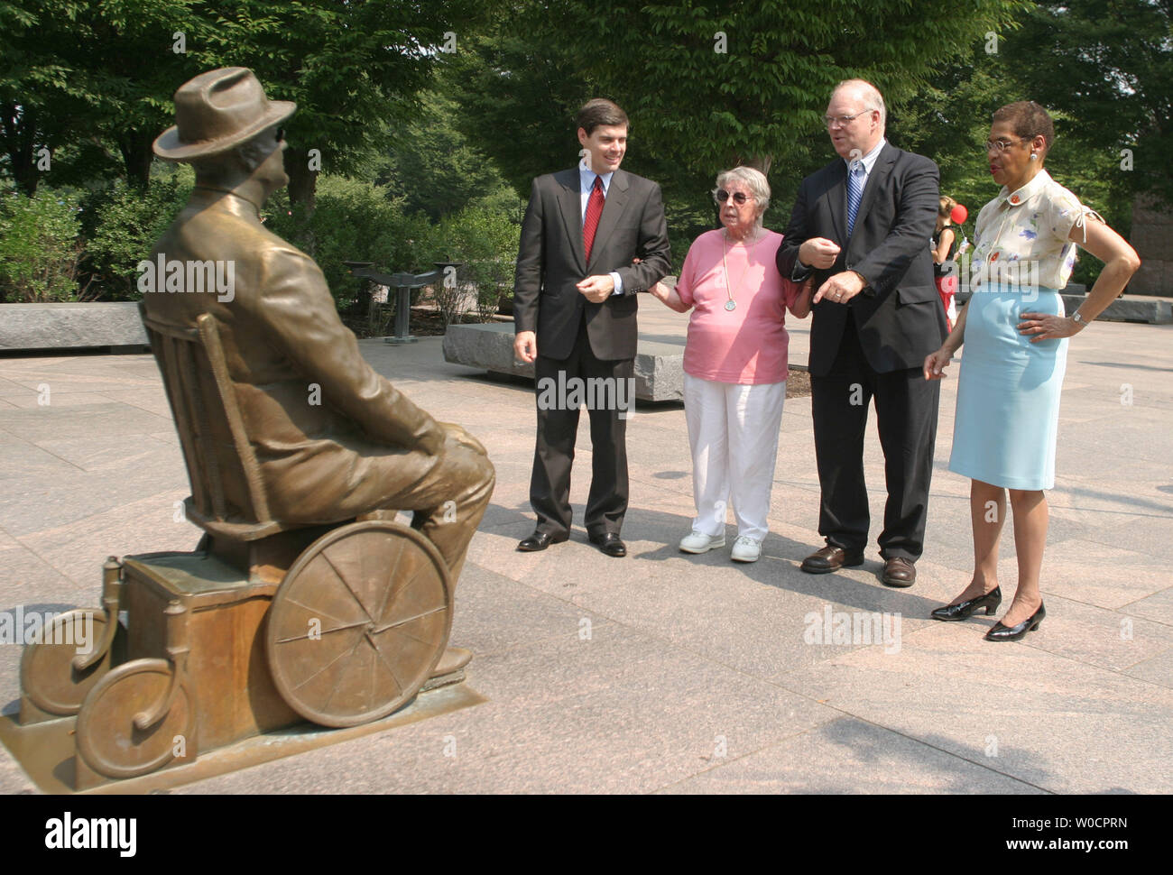 From the left, William A. Halter, former Deputy Commissioner and Acting Commissioner of Social Security under the Clinton Administration, Winnie Pineo a 97 year-old Vermont native and Social Security dependent, James Roosevelt, JR. grandson of President Franklin D. Roosevelt, and Congresswoman Eleanor Holmes Norton (D-DC), tour the FDR Memorial at a ceremony to kick off nationwide celebrations of the 70th anniversary of Social Security, at the FDR Memorial, in Washington, on Aug. 12, 2005. (UPI Photo/Kevin Dietsch) Stock Photo