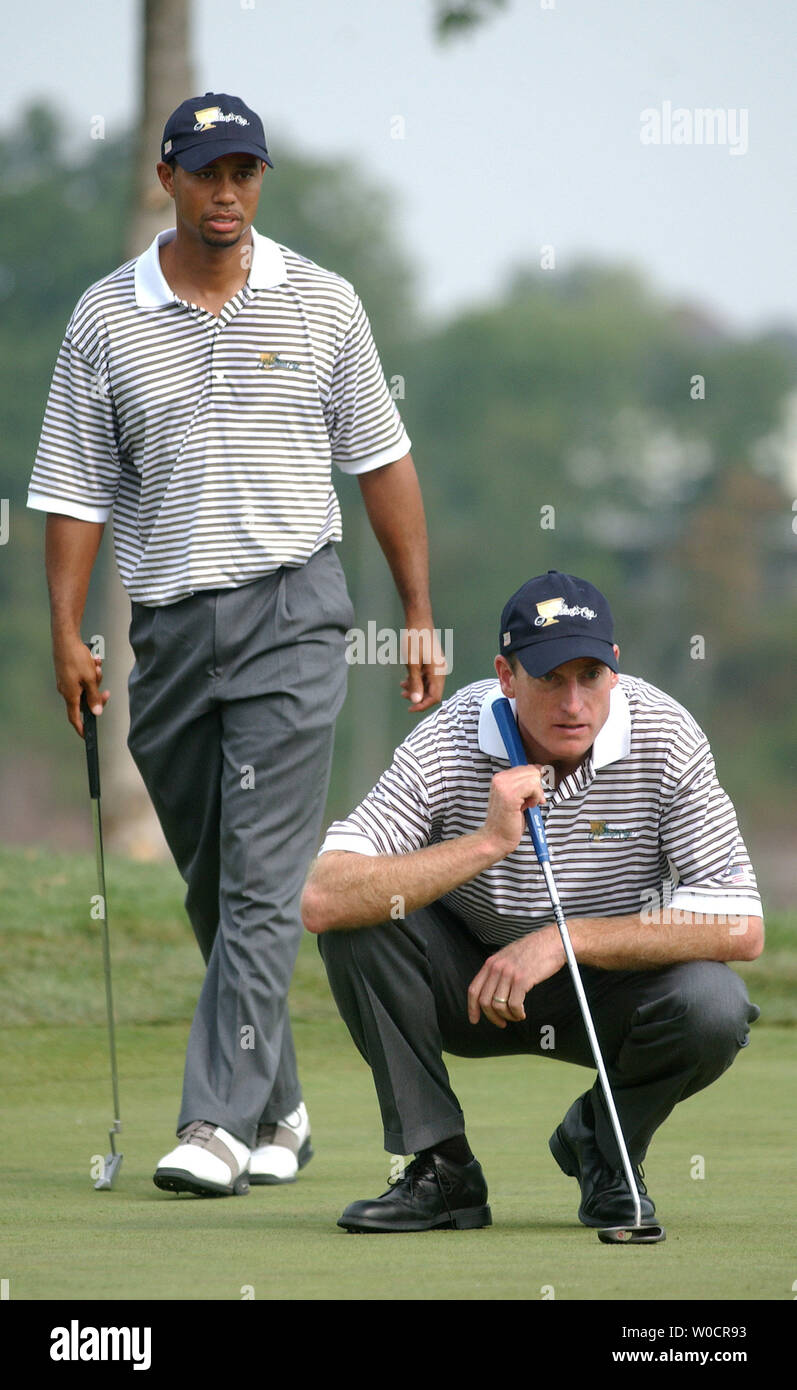 American team members Tiger Woods (L) and Jim Furyk line up a shot on the tenth green during the second round of the 2005 President's Cup at the Robert Trent Jones Golf Club in Gainesville, VA, on Sept. 23, 2005. The International team leads 3.5 to 2.5 after play was temporarily suspended due to lightning. (UPI Photo/Kevin Dietsch) Stock Photo