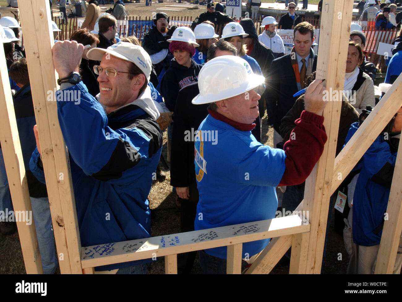 CEO of Habitat for Humanity international Jonathan Reckford (L) and President of Freddie Mac Gene McQuade write a note on a Habitat for Humanity house during the Habitat for Humanity America Builds Project, in Washington on November 18, 2005. The America Builds project is a week long 51 house build off for the the hurricane Katrina affected families of the Gulf Coast region. (UPI Photo/Kevin Dietsch) Stock Photo
