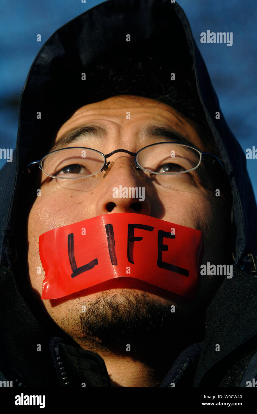 A Pro-Life demonstrator with the group Born 4 Life participates in a silent rally in front of the Supreme Court while the Court hears arguments on the Scheidler and Ayotte abortion case, in Washington on November 30, 2005. This is the third time abortion has come into debate in the Supreme Court. (UPI Photo/Kevin Dietsch) Stock Photo