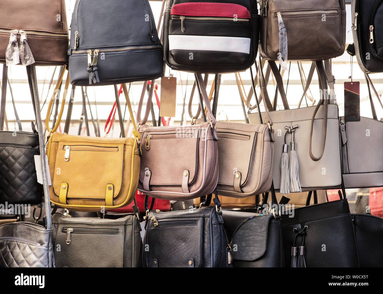 leather bags for sale on a market stand Stock Photo Alamy