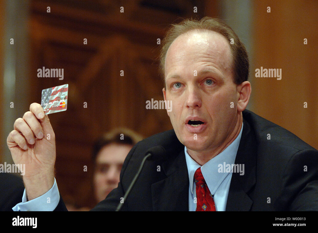 Gregory Kutz, managing director of forensic audits and special investigations, Government Accountability Office, holds up an ATM card like those given to hurricane victims as he testifies before the Senate Homeland Security and Governmental Affairs Committee about the waste and fraud generated in the aftermath of Hurricane Katrinta during a hearing on Capitol Hill in Washington on February 13, 2006. Witnesses described millions of dollars in fraudulent emergency payments and waste generated by poor oversight and planning by FEMA.   (UPI Photo/Roger L. Wollenberg) Stock Photo