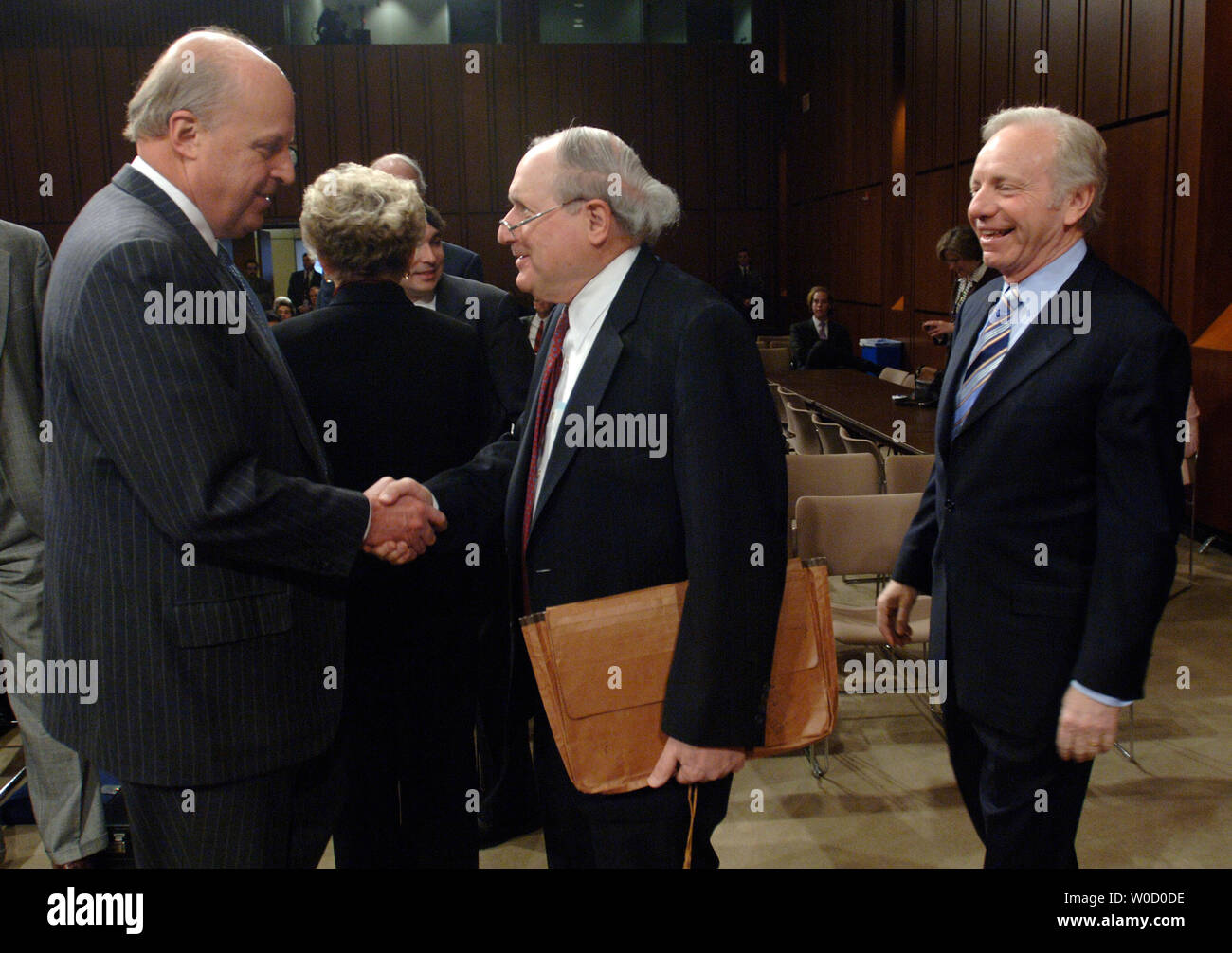 National Intelligence Director John Negroponte (L) greets Sen. Carl Levin (D-MI), as Sen. Joseph Liberman (D-CT) watches on, before testifying before a Senate Armed Services Committee Hearing on the worldwide threats to US national security, in Washington on February 28, 2006. (UPI Photo/Kevin Dietsch) Stock Photo