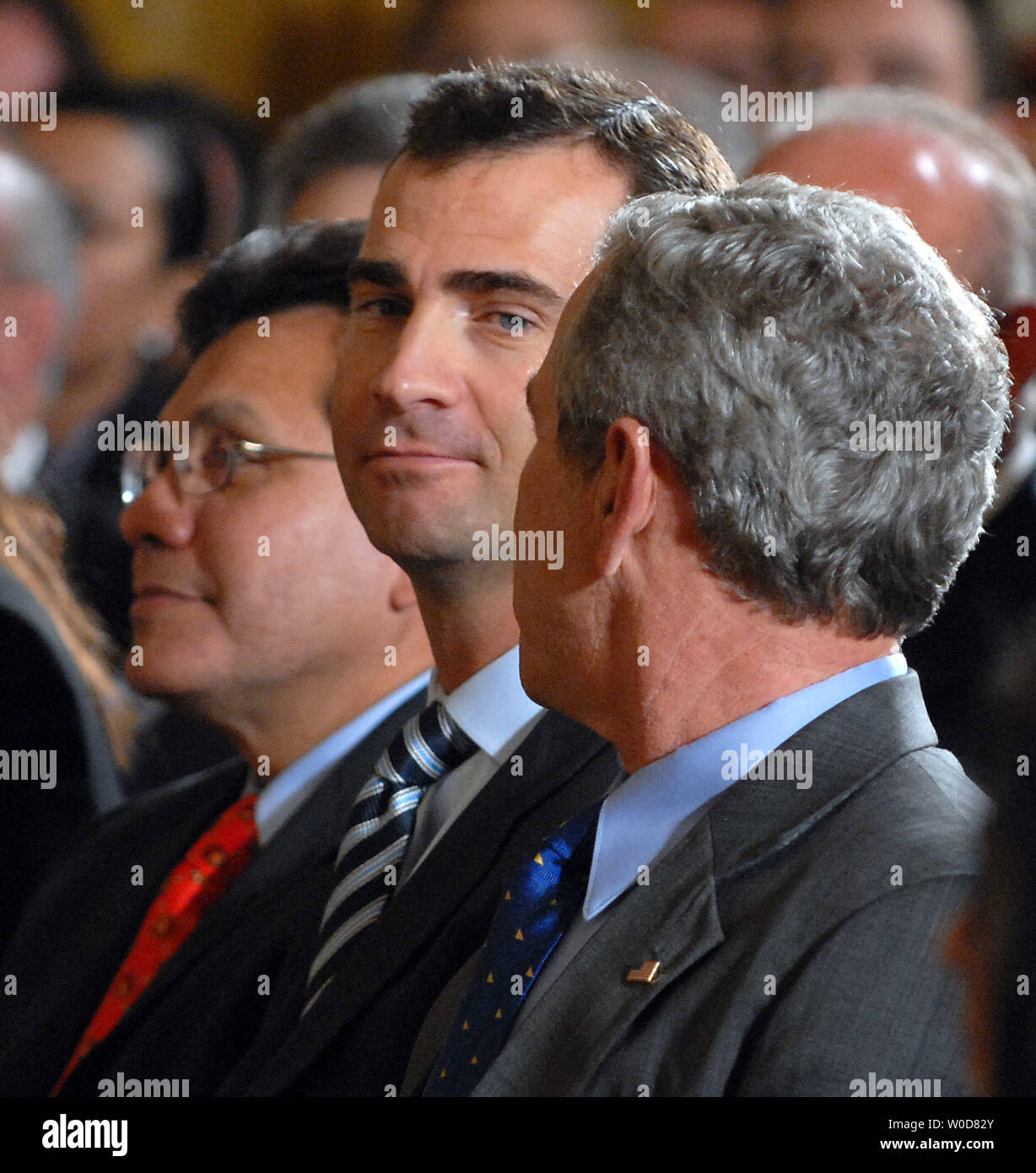 Spanish Crown Prince Felipe (C) joins Attorney General Alberto Gonzales (L) and U.S. President George W. Bush in a celebration of Hispanic Heritage Month in the East Room of the White House on October 6, 2006.   (UPI Photo/Roger L. Wollenberg) Stock Photo
