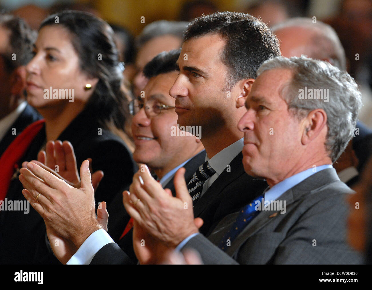 Spanish Crown Prince Felipe (C) joins Attorney General Alberto Gonzales (L) and U.S. President George W. Bush in a celebration of Hispanic Heritage Month in the East Room of the White House on October 6, 2006.   (UPI Photo/Roger L. Wollenberg) Stock Photo