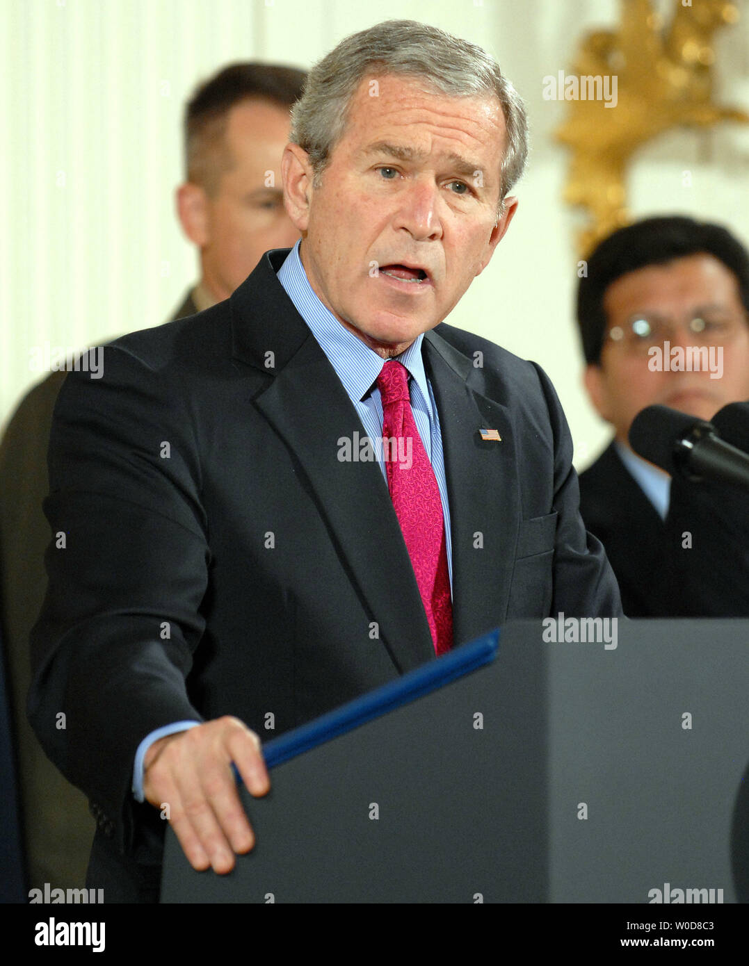 U.S. President George W. Bush speaks before signing S. 3930, the Military Commissions Act of 2006, a bill outlining the treatment of terrorism suspects, in the East Room of the White House on October 17, 2006. Behind Bush are Chairman of the Joint Chiefs of Staff Gen. Peter Pace (L) and Att. Gen. Alberto Gonzales.    (UPI Photo/Roger L. Wollenberg) Stock Photo