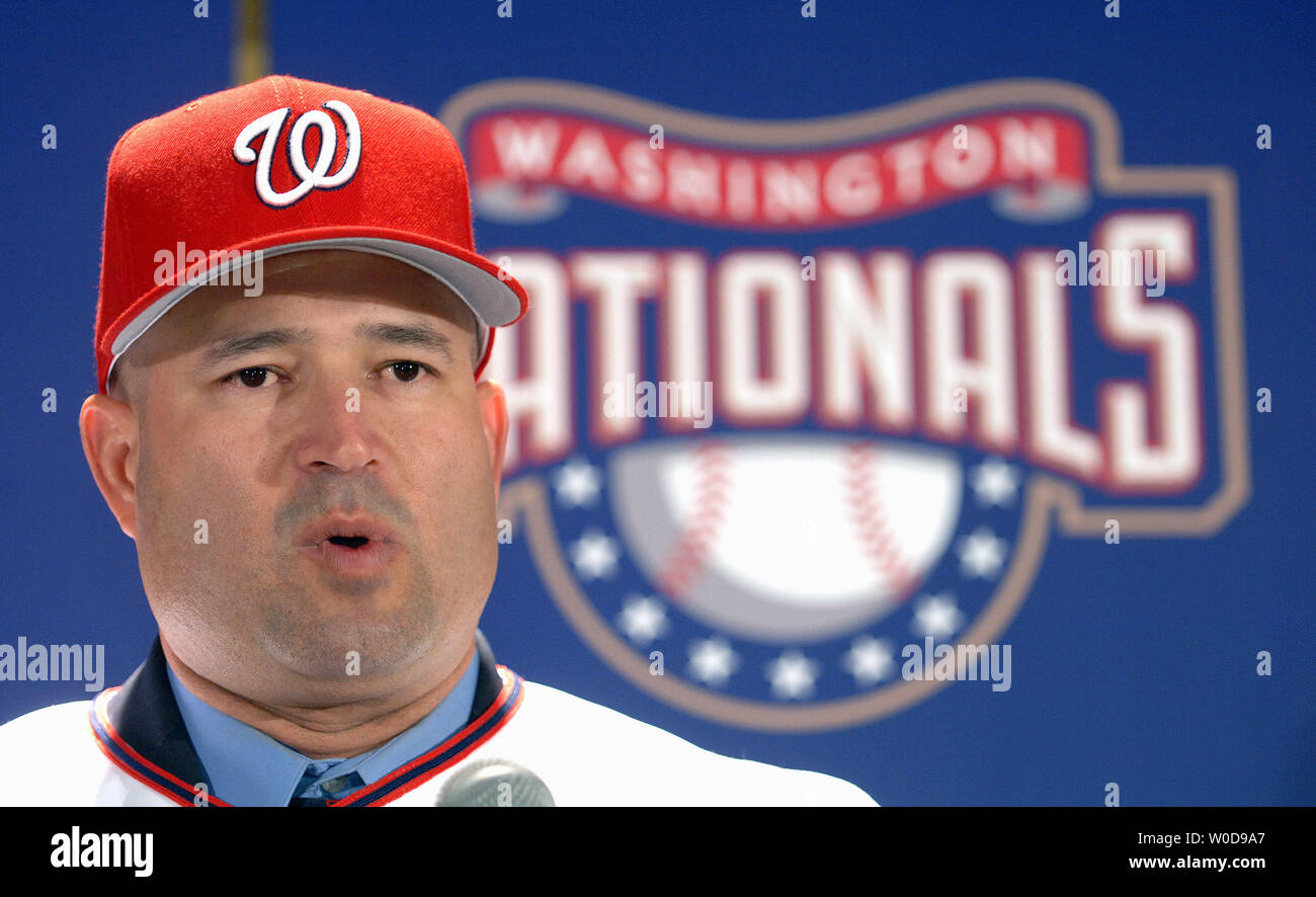 Manny Acta dons his jersey and hat after he was announced as the new Washington  Nationals baseball team manager during a news conference in Washington on  November 14, 2006. (UPI Photo/Roger L.