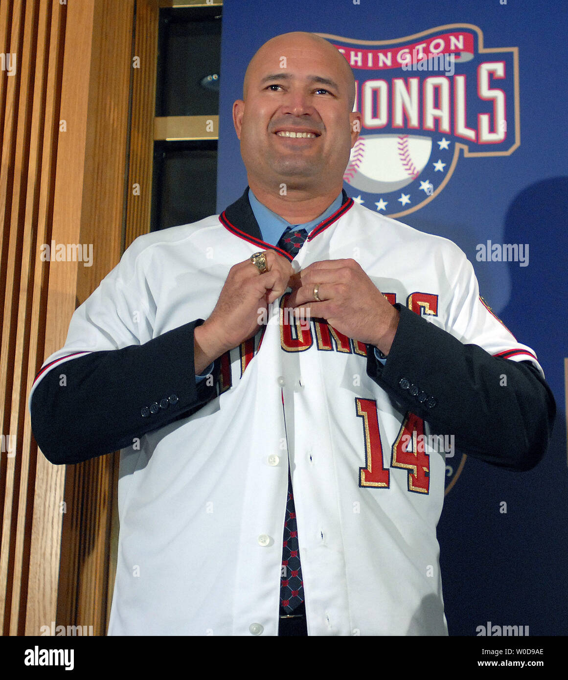 Manny Acta dons his jersey and hat after he was announced as the new Washington  Nationals baseball team manager during a news conference in Washington on  November 14, 2006. (UPI Photo/Roger L.