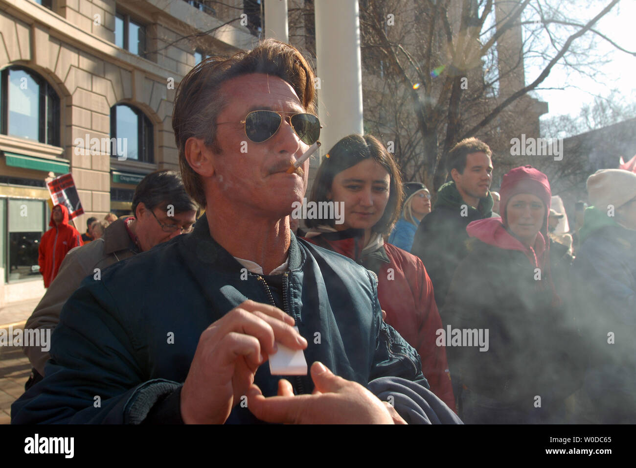 Actor Sean Penn lights up a cigarette after speaking at a peace rally